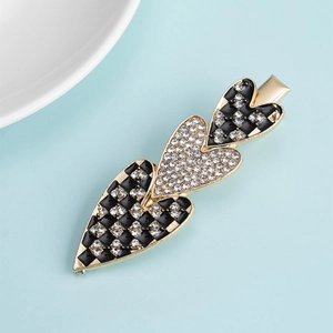 Fashionable gold alloy hair clip featuring three hearts with black checkerboard and rhinestones
