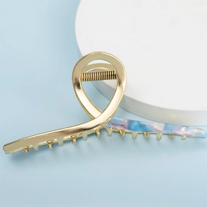 Elegant gold metal large hair claw with marble acetate design and strong spring