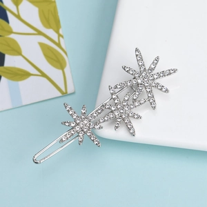 Elegant silver star hair clip with sparkling rhinestones on a minimalist background