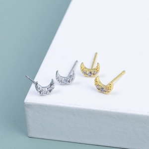Detailed macro view of S925 silver and 18K gold crescent moon stud earrings with zircon