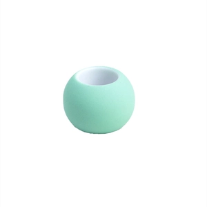 Close-up of a mint green round silicone bead with a center hole for DIY hair accessories