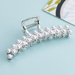 Detail shot of large silver metal hair claw clip with elegant double rows of white pearls