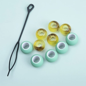 DIY colorful hair beads set with 9 resin beads and a black styling tool on blue background