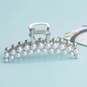 Elegant large silver metal hair claw clip with double rows of pearls on light blue background
