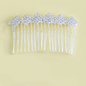 Detailed close-up of a silver hair comb with seventeen teeth and sparkling rhinestones