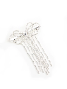 Detail of silver bow hair clip with sparkling rhinestone tassels for an elegant look