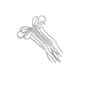 Detailed macro view of silver bow hair clip with sparkling rhinestone fringe tassels