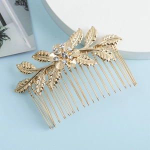 Peigne à cheveux de mariage doré avec fleur en strass et détails de feuilles