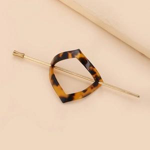 Minimalist tortoiseshell acetate hair pin with golden metal rod for elegant hairstyles