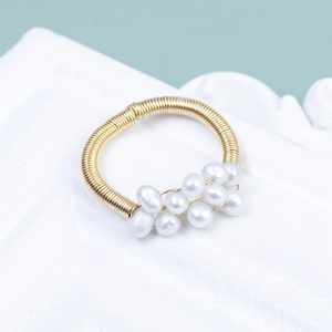 Handmade gold wire-wrapped ring with elegant natural white pearls on a vintage base