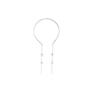 Detailed view of silver bow tassels with butterfly charms on an elegant metal headband