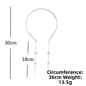 Detail view of silver bow headband with size markings for perimeter and tassel length