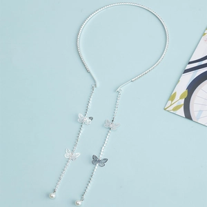 Silver bow headband with sparkling rhinestones, long tassel butterfly and pearl details