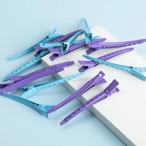 Detail of purple and blue metal salon hair clips with anti-slip hollow design