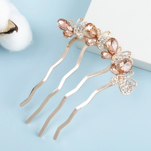 Detailed view of rhinestone butterfly hair comb with golden four-tooth wavy pins