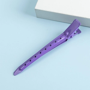 Minimalist purple metal hair clip with hollow circle pattern in a duckbill design