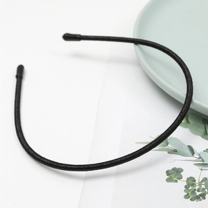 Slim black non-slip headband with thin ribbed fabric and rounded protective ends