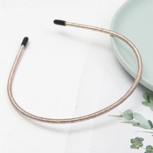 Minimalist champagne gold thin metal headband with non-slip texture and protective tips
