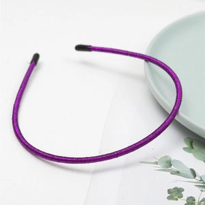 Detail of slim purple metallic headband featuring fine silk thread wrapping and non-slip tips