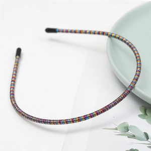 Detail of colorful metallic thin headband featuring non-slip protective black rubber tips