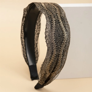 Elegant wide lace headband with gold and black leaf pattern weave and rhinestones