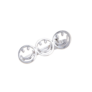 Silver metal hair clip featuring three hollow smile faces on a white background