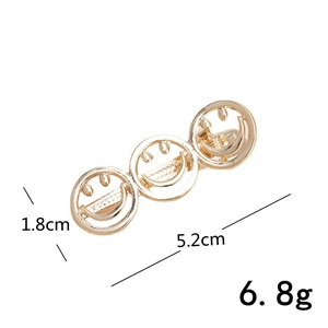 Golden metal hair clip with three smile faces measuring 5.2cm long and 1.8cm wide