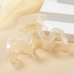 Close-up of translucent wavy hair claw clip showing smooth acrylic texture and metal spring