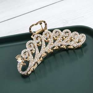 Golden peacock wave hair claw clip with sparkling white rhinestones for elegant styling