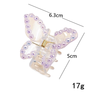 Detail view of butterfly hair claw with purple rhinestones showing 6.3cm width and 5cm height