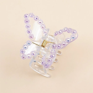 Elegant butterfly hair claw with purple rhinestones and transparent acrylic finish