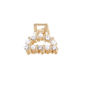 Mini gold metal hair claw with elegant pearls and sparkling rhinestones on white background