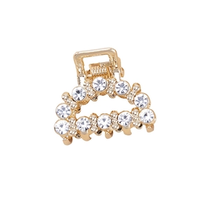 Elegant gold mini hair claw clip featuring sparkling white rhinestones on a white background