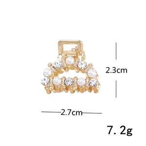 Detail view of mini gold hair claw showing 2.3cm height and 2.7cm width with pearls