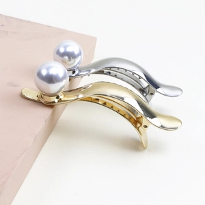 Elegant gold and silver metal hair claws with large pearl accents for women