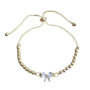 Minimalist gold bow bracelet with sparkling cubic zirconia crystals and adjustable bead chain
