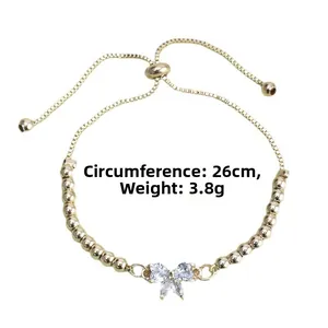Detail of adjustable gold bow bracelet with cubic zirconia and box chain showing dimensions