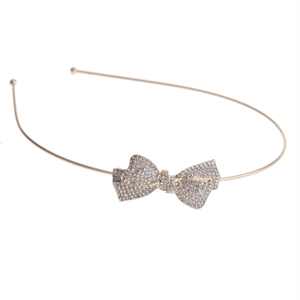 Elegant gold headband with a rhinestone bow knot featuring a minimalist 45-degree angle design
