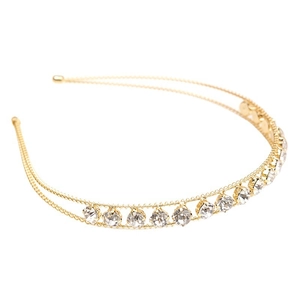 Close-up of golden double-layered headband featuring sparkling claw-set rhinestones