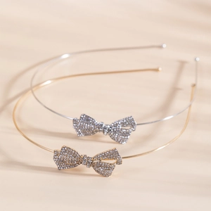 Elegant crystal bow headband in gold and silver finish with minimalist metal alice band