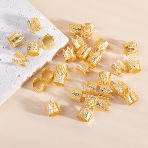 Golden hollow crown hair rings set for dreadlocks styling on stone background