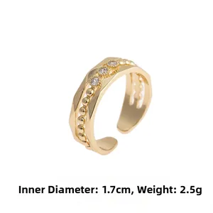 Detail of adjustable gold copper ring with three cubic zirconia stones and dimensions