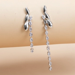 Close-up of asymmetric 925 silver fringe earrings with sparkling marquise zircons