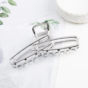 Elegant silver metallic hollow hair claw clip with polished finish on a white background