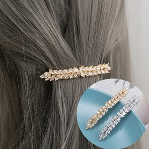 Elegant leaf hair clip set with sparkling leaf-shaped zircon crystals in gold and silver