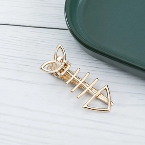 Elegant gold alloy fishbone hair clip with hollow heart design and non-slip metal texture