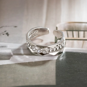 Macro detail of S925 sterling silver adjustable ring with three zircon stones