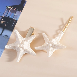 Close-up of cream starfish hair clip set with realistic resin texture for beach style