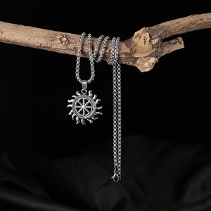 Retro stainless steel sun pendant necklace displayed on a wooden branch with box chain