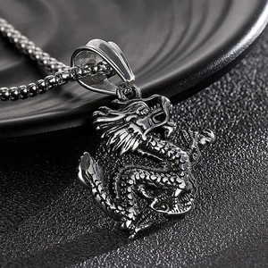 Macro view of detailed Chinese dragon pendant in stainless steel with polished silver finish